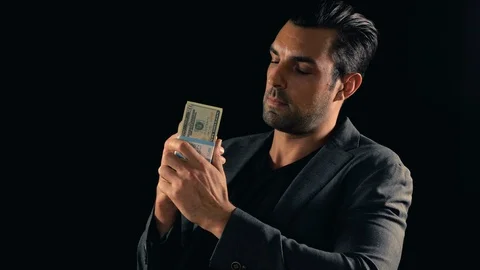 Handsome man plays with a stack of cash Vídeo Stock 111602107