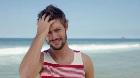 Handsome man posing on beach Stock Footage 49613346