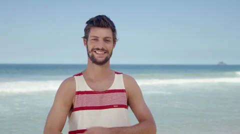 Handsome man posing on beach Stock Footage 49613707