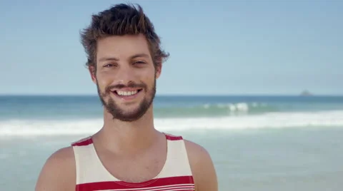 Handsome man posing on beach Stock Footage 49614340