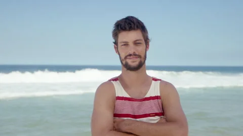 Handsome man posing on beach Stock Footage 49615113