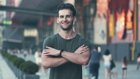 The handsome man posing on camera on the cityscape background. slow motion Video stock 139203862
