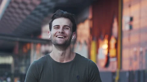 The handsome man posing on camera on the cityscape background. slow motion Stock Footage 139204109