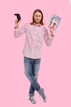 Handsome man posing with game controller and magazine Stock Photos