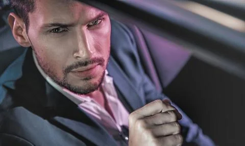 Handsome man posing in the limousine Stock Photos