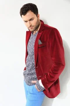 Handsome man posing in a red jacket Stock Photos