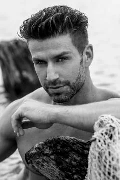 Handsome man is posing in the river. Stock-Fotos