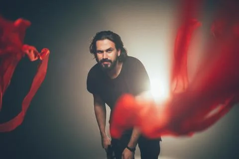 Handsome man posing in studio in backlight. Stock Photos