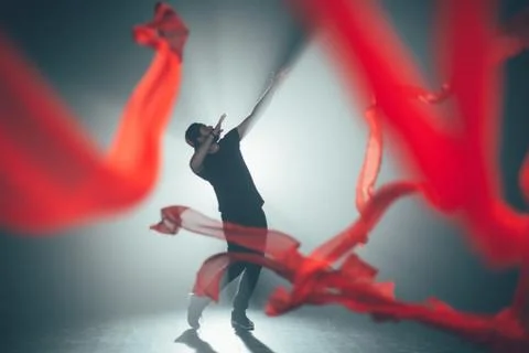 Handsome man posing in studio in backlight. Stock Photos