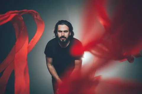 Handsome man posing in studio in backlight. Stock Photos