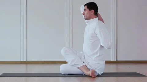 Handsome Man Practicing Yoga in a Yoga Studio. Coach yoga. Stock Footage 59730043
