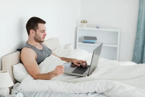 Handsome man purchasing online Stock Photos