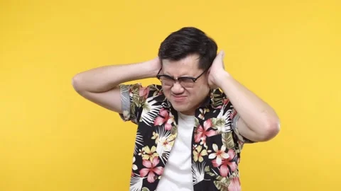 Handsome Man put his hand on his ears on camera. Suffer guy from music make a lo Stock Footage 144666761