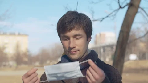 Handsome man puts on protective mask Stock Footage 127298895