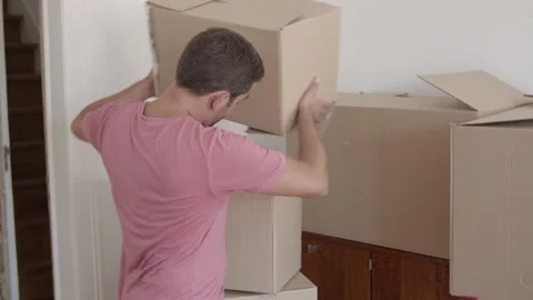 Handsome man putting two boxes on another one Stock-Footage 139525725