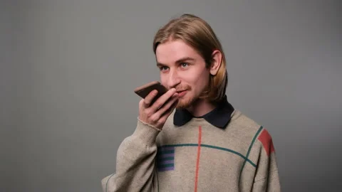 Handsome man recording voice message Stock Footage 229138079