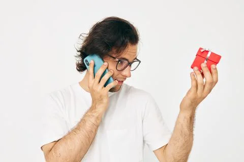 Handsome man Red gift box telephone communication Lifestyle unaltered Stock Photos