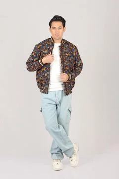 Handsome man in red jacket and black leather jacket on grey background Stock Photos