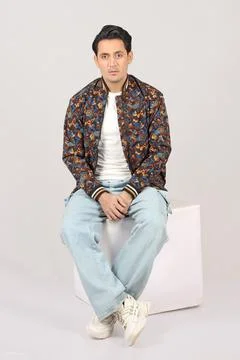 Handsome man in red jacket and black leather jacket on grey background Stock Photos