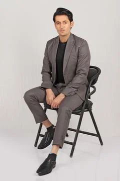 Handsome man in red jacket and black leather jacket on grey background Stock Photos
