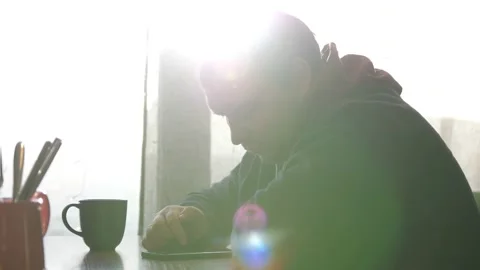 Handsome man at restaurant using smartphone. Man using smartphone touchscreen in Stock Footage 150954698