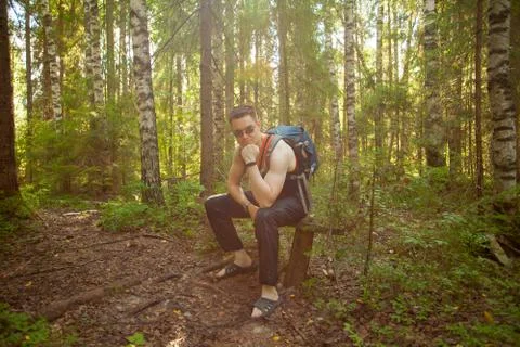 Handsome man resting on  bench in  spring forest Stock Photos