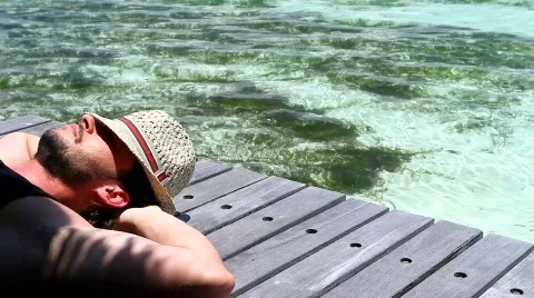 Handsome man resting near water at Maldives Stock Footage