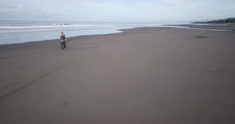 Handsome man ride his custom motorbike. Drone aerial. Video stock 91790789