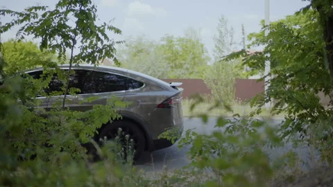 Handsome man riding backward on his electric  car Stock Footage 90672595