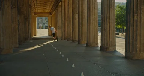 Handsome man on roller skates doing beautiful tricks and spins in city location  Stock Footage 117469830