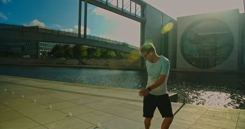 Handsome man on roller skates doing beautiful tricks and spins in city location  Stock Footage 117469840