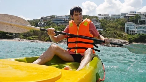 Handsome man Rowing Kayaking In a Beautiful Lagoon in the sea. slow motion Stock-Footage 87027402