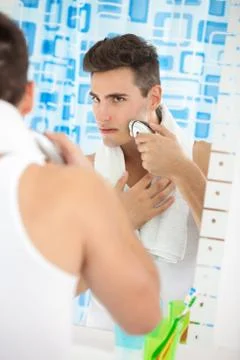 Handsome man shaving Stock Photos