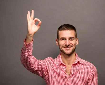Handsome man showing okay sign Stock Photos