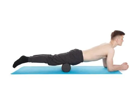 Handsome man shows exercises using a foam roller Stock Photos
