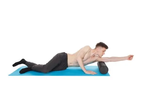 Handsome man shows exercises using a foam roller Фото