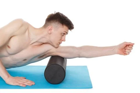 Handsome man shows exercises using a foam roller Stockfoto's