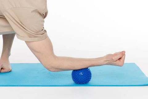 Handsome man shows exercises using the ball with spikes Stock Photos