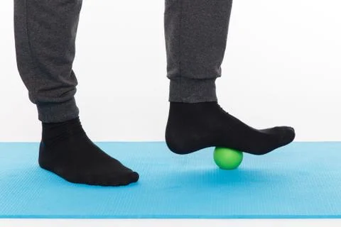 Handsome man shows exercises using the ball with spikes Fotos Stock