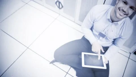 Handsome man sitting and using a tablet 스톡 사진
