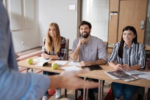 Handsome man sitting between his beautiful colleagues Stock Photos