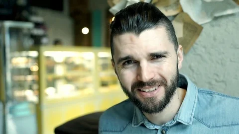 Handsome man sitting in the cafe and negates someone's accusation Stockbeeldmateriaal 73227043
