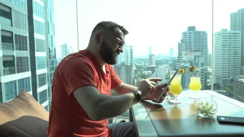 Handsome man sitting in the cafe and browsing internet on tablet Stock Footage 88541187