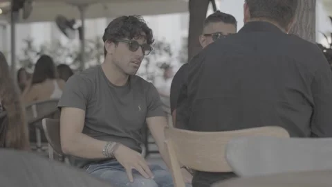 A handsome man sitting in a café in Paphos, Cyprus Stock-Footage 344056738