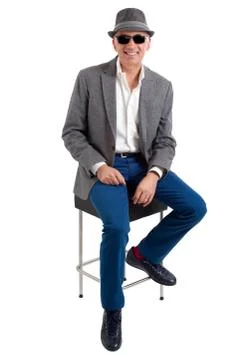 Handsome man sitting on a stool Stock Photos