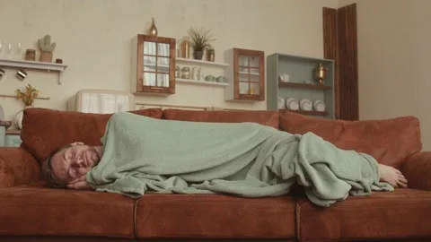 Handsome man sleeping on sofa at home Stock Footage 138552436