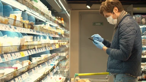 Handsome man with smartphone in the store Stock Footage 128471881