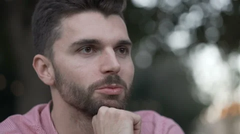 Handsome man smiling while talking with someone outdoors 스톡 동영상 67828412