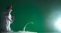 The handsome man smoke an electronic cigarette and gesture on the green bac.. Photo