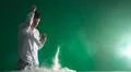 The handsome man smoke an electronic cigarette and gesture on the green bac.. Photo